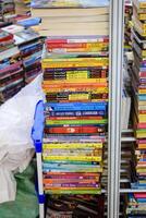 New Delhi, India, July 17 2024 - Variety of Books on shelf inside a book-stall at Delhi International Book Fair, Selection of books on display in Annual Book Fair at Bharat Mandapam complex photo