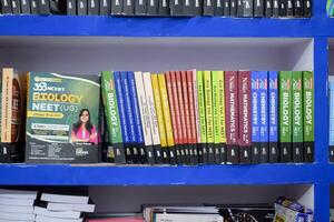 New Delhi, India, July 17 2024 - Variety of Books on shelf inside a book-stall at Delhi International Book Fair, Selection of books on display in Annual Book Fair at Bharat Mandapam complex photo