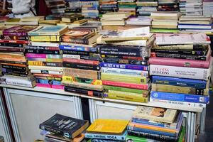 New Delhi, India, July 17 2024 - Variety of Books on shelf inside a book-stall at Delhi International Book Fair, Selection of books on display in Annual Book Fair at Bharat Mandapam complex photo