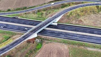Aerial View of a Winding Highway Overpass Amidst Lush Fields During Early Autumn video