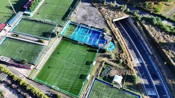 Vibrant Aerial View of Diverse Soccer Fields Surrounded by Nature on a Sunny Day video