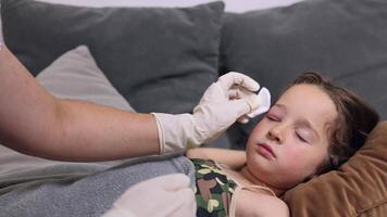 a small childhood infection on the eyelid caused by insect, mosquito or bee bites that causes swelling, redness, heat and itching. The doctor is trying to remove the swelling of the child's eye video
