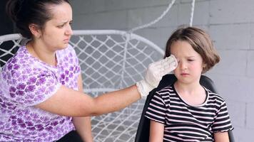 a small childhood infection on the eyelid caused by insect, mosquito or bee bites that causes swelling, redness, heat and itching. Allergy after mosquito bites in a little girl video