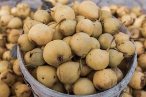 Yellow pears in a basket on the counter of a farmers market. photo
