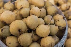Yellow pears in a basket on the counter of a farmers market. photo