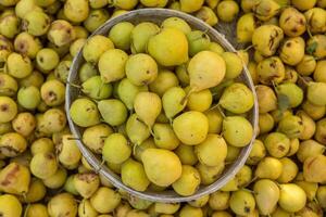 Yellow pears in a basket on the counter of a farmers market. photo