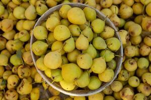 Yellow pears in a basket on the counter of a farmers market. photo