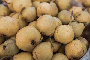 Yellow pears in a basket on the counter of a farmers market. photo