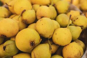 Yellow pears in a basket on the counter of a farmers market. photo