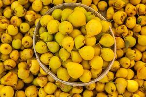 Yellow pears in a basket on the counter of a farmers market. photo
