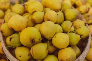 Yellow pears in a basket on the counter of a farmers market. photo