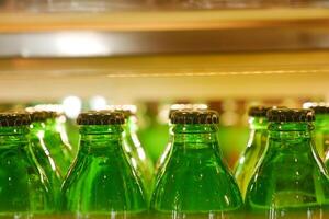 Vintage beverage bottles with colorful caps on bar shelf create a nostalgic retro drinks display photo