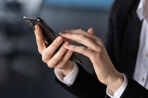 Close-up of a person using a smartphone in a professional office setting, highlighting technology in business. photo