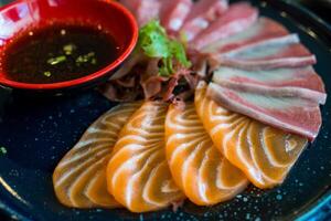 Fresh thinly slice of salmon sashimi, Accompanied with shoyu sauce photo