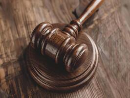 Wooden judge's gavel on the table as a trial concept photo