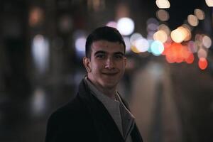 Smiling Meedle Eastern man walking down street near modern office building, photo