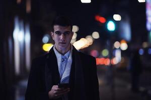 Smiling Meedle Eastern man walking down street near modern office building, photo