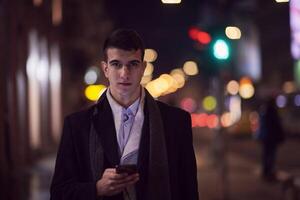 Smiling Meedle Eastern man walking down street near modern office building, photo