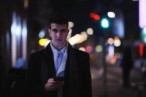 Smiling Meedle Eastern man walking down street near modern office building, photo