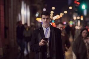 Smiling Meedle Eastern man walking down street near modern office building, photo