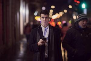 Smiling Meedle Eastern man walking down street near modern office building, photo