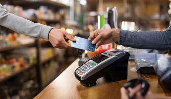 A customer at a cafe or restaurant completes a seamless transaction, using a credit card to pay at the cashier, showcasing the convenience of digital payment in the dining experience photo