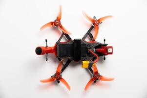 FPV racing drone with propellers lies on a white background, close-up. Modern technologies photo