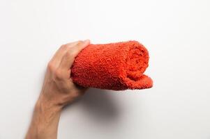 Drying hands with a towel. The concept of caring for cleanliness, personal hygiene. A man holds out a clean folded small towel photo