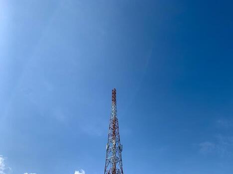 a large tower with a red and white antenna photo
