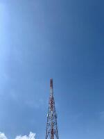 a large tower with a red and white antenna photo