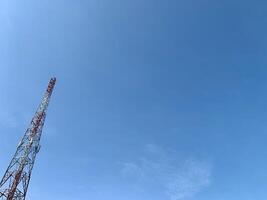 a large tower with a red and white antenna photo