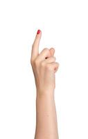 Female hand pointing, index finger extended and varnished in red, signaling direction. Right hand photo
