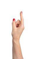 Gesture of pointing with an outstretched index finger, red varnish on the nails of a Caucasian woman photo