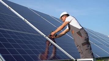 Worker installing solar cell farm power plant eco technology video