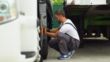 Professional mechanic using socket wrench while changing truck tire on car service video