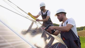 Two solar panel technicians installing solar panels on a sunny day video