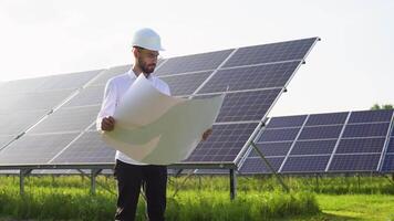 An engineer checks the documentation of the solar station video