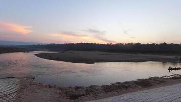 Sauraha, Nepal - 25th november , 2023 - Beautiful time lapse sunset over Rapti river that separates Sauraha and Chitwan National Park. Boat ride across river to Chitwan tropical jungles in Nepal video