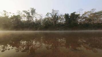 Time lapse fishermen fishing with net ride on boat in Chitwan national park. Jungles buffer zone on misty morning video