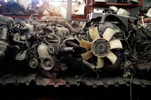 Auto parts and secondhand engine components in auto spare parts store. Spare parts of vehicle in warehouse. photo