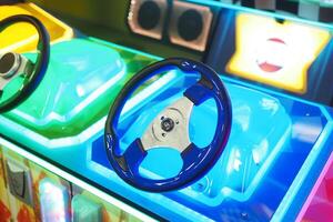 A closeup view of a illuminated steering wheel from an arcade racing game machine photo
