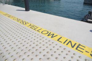 Warning Sign Located on Dock It is Prohibited to Cross the Distinct Yellow Line photo