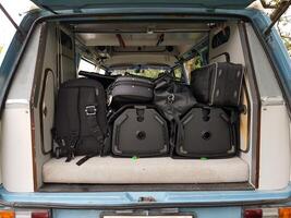 The instruments in the cases are loaded into the van. photo