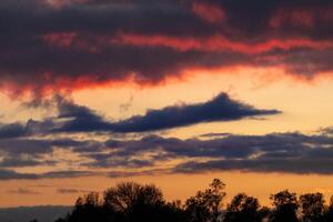 beautiful evening sky with clouds shaped like a fighter jet photo