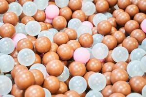 Close-up of colored plastic balls in the pool of the playroom. With space to copy photo