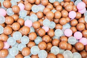 A children's party, a playroom, a box filled with small colored balls. Colored plastic balls in the pool of the playroom in close-up. With space to copy photo