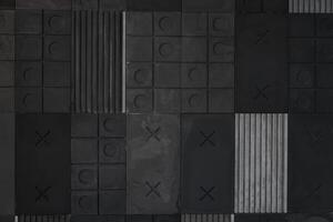 Textured black, gray geometric background made of concrete with stripes, squares, circles, crosses, tic-tac-toe, copy space. Concept of modern abstract creative wall design with bulky convex elements photo