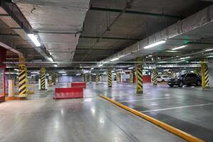 Selective focus of underground parking in a shopping mall. Parking restrictions. With a space to copy. Navigation in the parking lot. Free parking space. photo