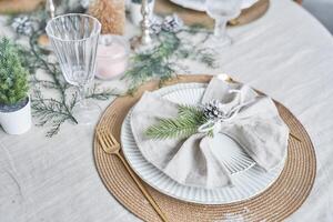 Close-up of Christmas serving, plate, spoon and fork, on a table with a light tablecloth, top view. Winter holiday theme, design with copy space photo