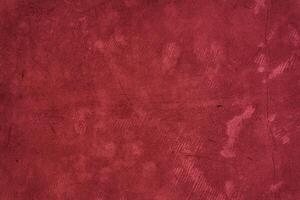 The surface of old concrete with stains. The color of 2023, viva magenta red with space to copy photo